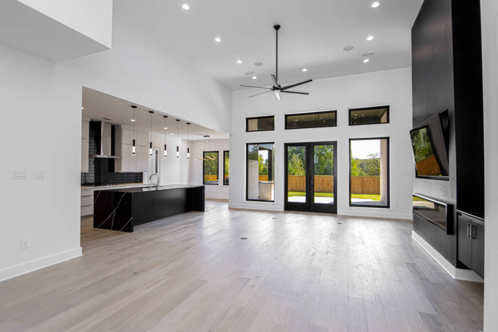 Open floor plan showing living room and kitchen from home in Natural Trail Estate