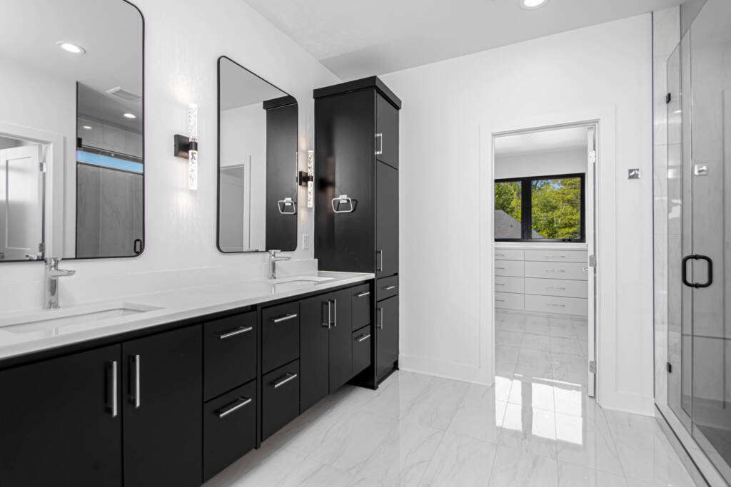 Modern master bathroom with walk-in closet from home in Natural Trail Estate